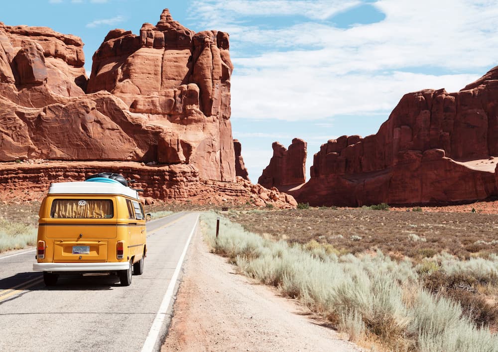 Traveler enjoying a scenic view with a backpack and travel essentials for a stress-free trip